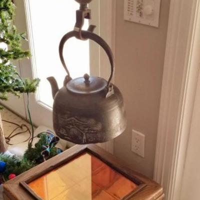 Japanese iron tea kettle (tetsubin) hung on a jizaikagi. $300
