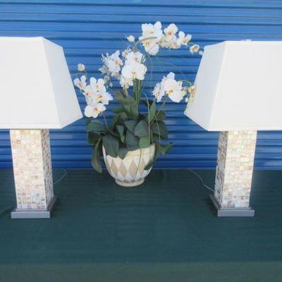 Matching table lamps with sea shell pieces in a mosaic style covering the base
