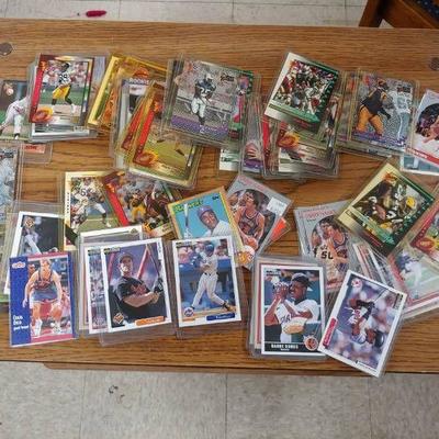 Large Lot of Trading Cards in Protective Sleeves.