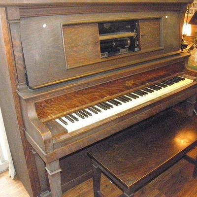Antique player piano with over 90 piano rolls