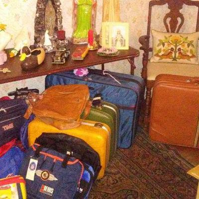 Religious icons, ceramic animals and vintage luggage and some current travel bags