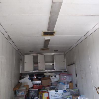 Big Kenny's 18' Enclosed Pull-Along Trailer.  Under the Top Cabinets, There is a Work Counter with Cabinets.  (Bins are...