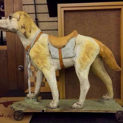 French paper mache dog on metal wheels