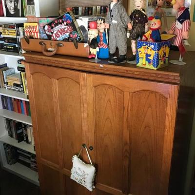 Oak cabinet, books, music, dolls, and more in backyard cottage