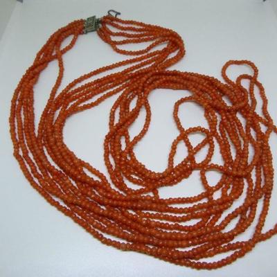 Five strand salmon colored natural coral opera length necklace.  Sterling clasp.