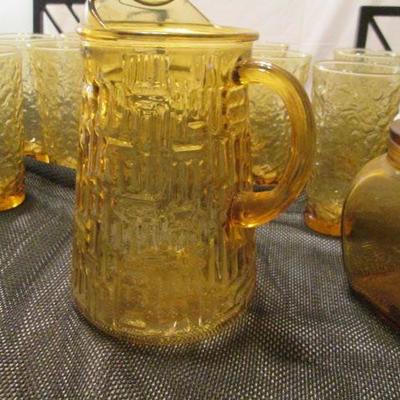 Vintage amber glass pitcher, tumblers, and other drinking ware