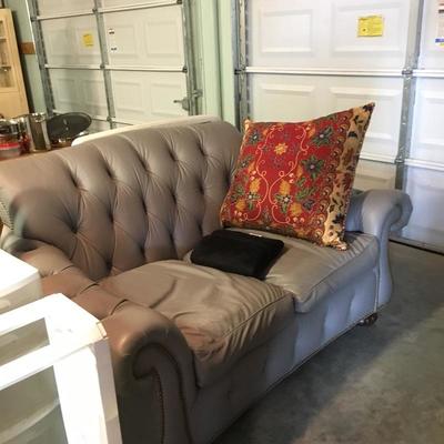 One of two grey leather love seats - cat claw damage