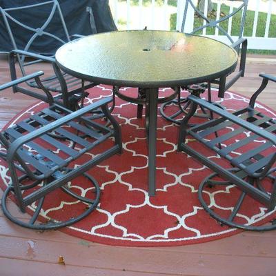 Patio table, chairs, and rug.
