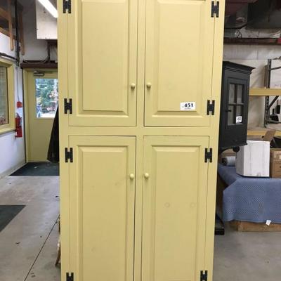 Yellow cupboard with raised panel doors