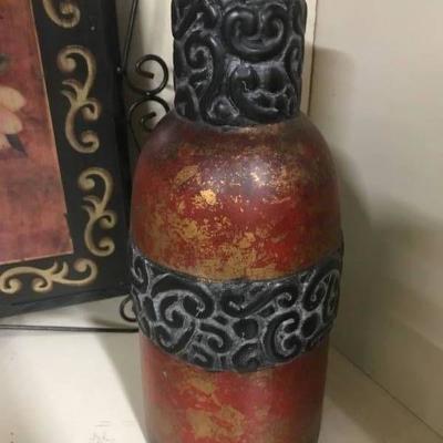 Rusty colored Vase with black texture around top a ...