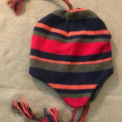 Stripped stocking hat with ear flaps and pom poms