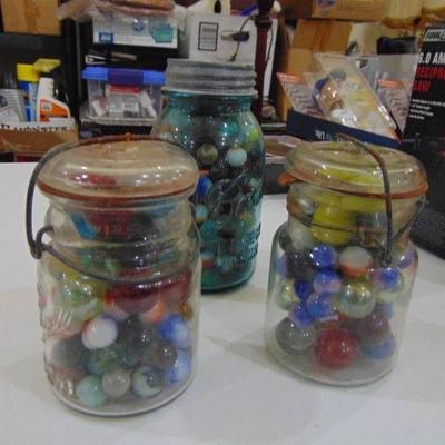 3 jars of various marbles