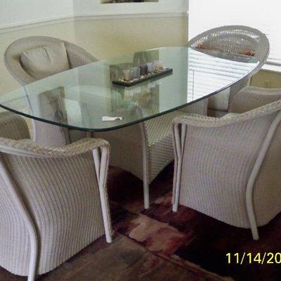 Wicker Pedestal Glass top with 6 Wicker Chairs.
