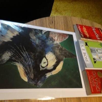 Lot with books and a cat picture.