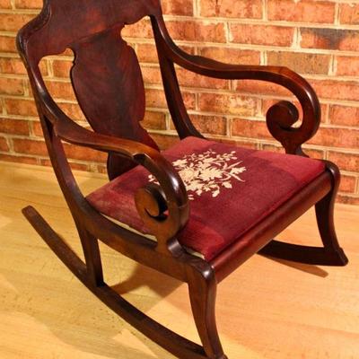 antique Empire style rocking chair with needlepoint seat