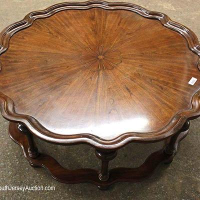  Burl Mahogany Carved Scalloped Round Coffee Table in the manner of Baker Furniture

Located Inside â€“ Auction Estimate $100-$300 