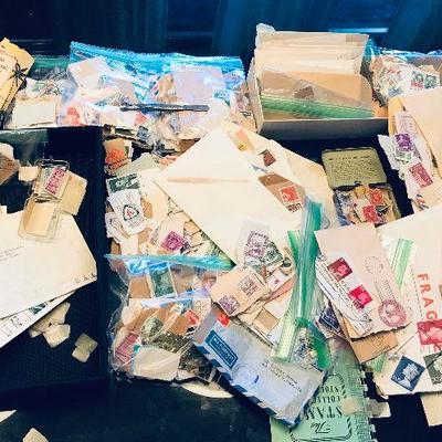 Large collection of loose stamps. Some on paper, mint and used. Envelopes full of stamps. Old covers, plus old universal hinges and...