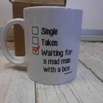 Coffee mug waiting for a mad man with a box