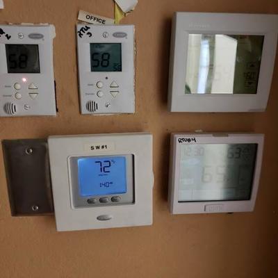 Digital thermostat controllers in office for AC un ...