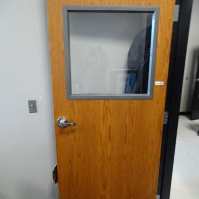 Metal door with window, frame not included.