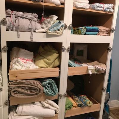 lots and lots of table, bed and bath linens, pillows, area rugs and window shades