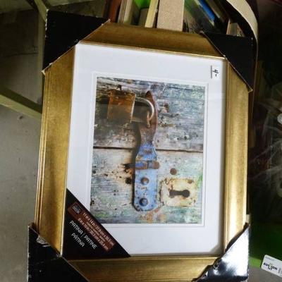 Lot of picture frames and pictures.