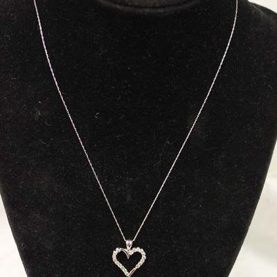  10 Karat White Gold Â½ CTW Diamond Heart Pendant and Necklace â€“ auction estimate $200-$500 
