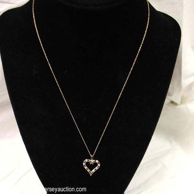  14 Karat Yellow Gold 1/5 CTW Diamond Heart Pendant and Necklace â€“ auction estimate $200-$500 