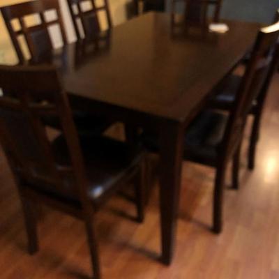 Table with six chairs.  Chairs are padded.