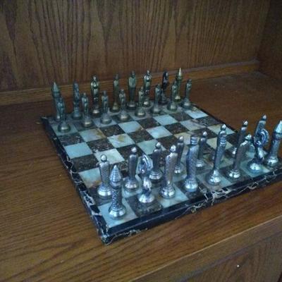 Stone Chessboard with Silver and Brass Colored Pieces