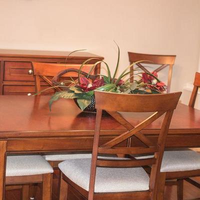 Dining table with six chairs and inlaid accent by Winners Only.