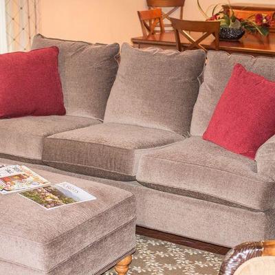 Dark gray Bassett 89â€ couch with matching ottoman.