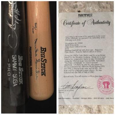 Two signed bats inside of a shadow box. Duke Snider and Sammy Sosa game day bats with their signatures. Estate sale prices: Sammy Sosa @...