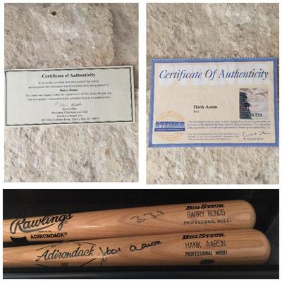 Two signed bats inside of a shadow box. Barry Bonds and Hank Aaron (HOF) bats with their signatures. Each has a certificate. Estate sale...