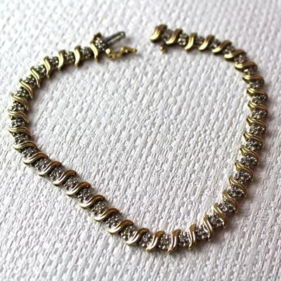collection of fine jewelry in 10K, 14K, and 18K gold, some solid pieces and some with stones - here a 10K gold bracelet with diamonds