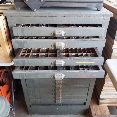 Antique letterpress typeset wooden cabinet filled with 1000's of metal typeset letters.