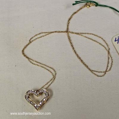 14 Karat Yellow Gold Â¼ CTW Diamond Heart Pendant and Chain â€“ auction estimate $300-$600 