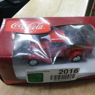 Two Coca Cola Matchbox cars, and a Piggy bank