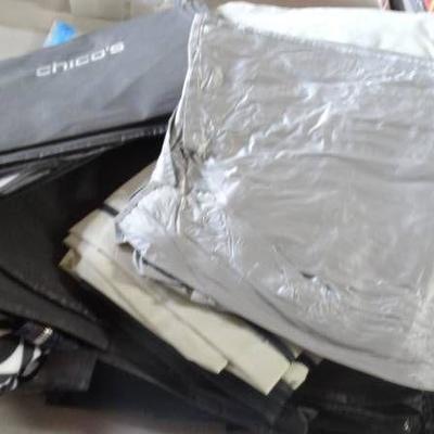 Lot of various clothes bags.