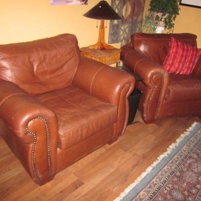 PAIR NATUZZI LEATHER TUFTED ARM CHAIRS