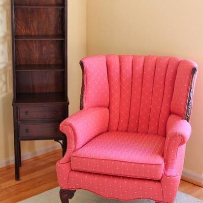 tufted wing back chair with carved wood decoration