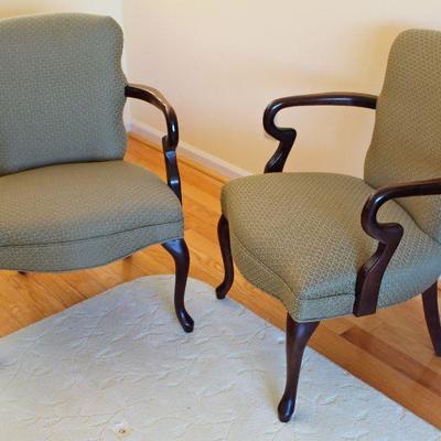 upholstered chairs with curved wood arms and Queen Anne style legs