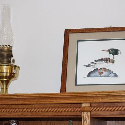 Artwork and brass oil lamp.