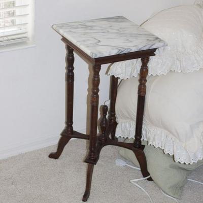 One of a pair of antique marble top tables