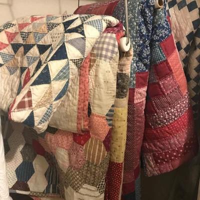 Various hand stitched quilts.