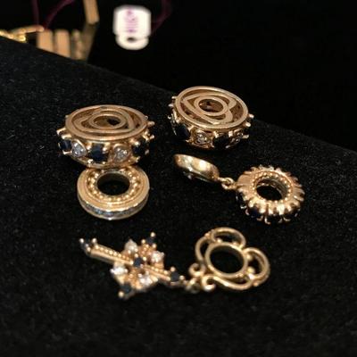 Storywheels 14K gold with diamonds and sapphires. These are gold charms. Range between $125 - 200.
