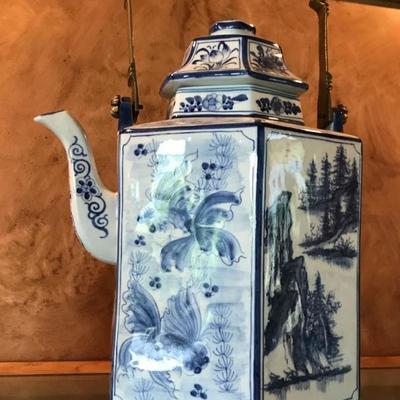 Vintage porcelain Chinese tea pot hand painted scenery in blue and white. With a heavy brass handle and lid. $125