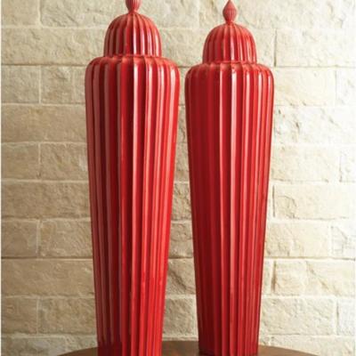 These extra large (over 4 feet tall!) lidded red fluted jars are worth between $550 - $750 each....