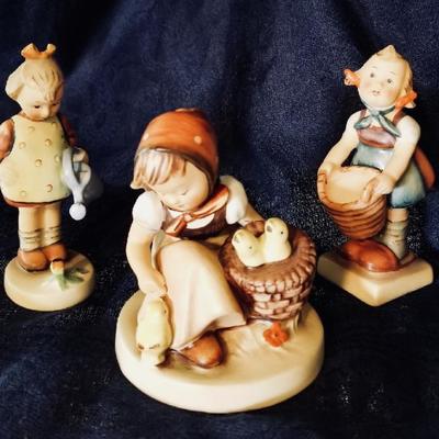 Hummel figurines. [left] $22 .... [center] $45 .... [right] $18
