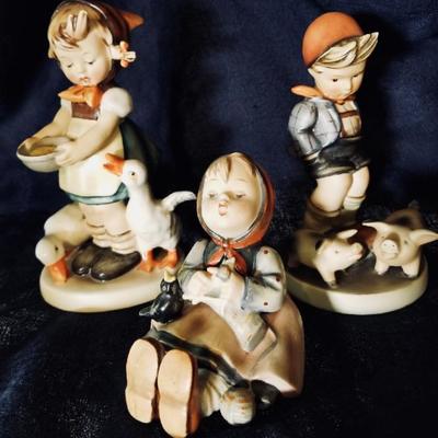 Hummel figurines. [left] $45 .... [center] $18 .... [right] $60